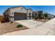 Charming single-story home featuring desert landscaping, a two-car garage, and a welcoming entrance at 40918 W Hillman Dr, Maricopa, AZ 85138