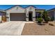 Charming single-story home featuring a neutral color palette, desert landscaping, and a two-car garage at 40918 W Hillman Dr, Maricopa, AZ 85138