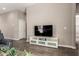 Modern living room featuring a mounted television and tile flooring at 40918 W Hillman Dr, Maricopa, AZ 85138