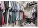 Spacious walk-in closet with ample hanging space, shelving, and a shoe rack for organized storage at 40918 W Hillman Dr, Maricopa, AZ 85138