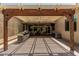 View of the covered patio with outdoor kitchen and stone fireplace at 4318 N 180Th Dr, Goodyear, AZ 85395