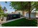 Backyard oasis featuring a hot tub, artificial grass, and privacy landscaping at 4318 N 180Th Dr, Goodyear, AZ 85395