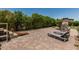 The beautiful backyard features a stone fireplace, patio with lounge chairs, and privacy landscaping at 4318 N 180Th Dr, Goodyear, AZ 85395