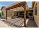 The beautiful outdoor covered patio area with a stone fireplace and outdoor kitchen at 4318 N 180Th Dr, Goodyear, AZ 85395