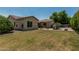 The outdoor patio area with seating, outdoor kitchen, stone fireplace, and large lawn at 4318 N 180Th Dr, Goodyear, AZ 85395