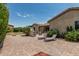 The private backyard features an outdoor stone fireplace, patio and lounge chairs at 4318 N 180Th Dr, Goodyear, AZ 85395
