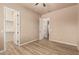 Bedroom with wood-look floors and access to an attached walk-in closet at 4318 N 180Th Dr, Goodyear, AZ 85395