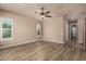 Spacious bedroom with wood floors, a ceiling fan, plantation shutters and dual closets at 4318 N 180Th Dr, Goodyear, AZ 85395