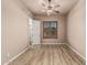 Bedroom featuring wood-look floors, ceiling fan, shuttered windows, and a walk-in closet at 4318 N 180Th Dr, Goodyear, AZ 85395