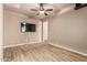 Spacious bedroom with wood floors, a ceiling fan, recessed lighting, and a TV at 4318 N 180Th Dr, Goodyear, AZ 85395