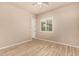 Bedroom with wood-look floors and bright window overlooking green space at 4318 N 180Th Dr, Goodyear, AZ 85395