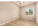 Bright bedroom with wood-look floors, ceiling fan, and window with wood blinds at 4318 N 180Th Dr, Goodyear, AZ 85395