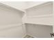 Walk-in closet featuring shelves and hanging rods for optimal storage solutions in a well-lit area at 4318 N 180Th Dr, Goodyear, AZ 85395