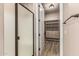 Walk in closet next to a shower featuring built in shelving and a wood look floor at 4318 N 180Th Dr, Goodyear, AZ 85395