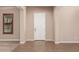 Bright entryway featuring tiled flooring and a white front door, creating a welcoming space at 4318 N 180Th Dr, Goodyear, AZ 85395