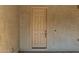 Close up of the wood paneled front door with a doorbell and security system at 4318 N 180Th Dr, Goodyear, AZ 85395