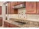 Kitchen details including cooktop and granite countertops at 4318 N 180Th Dr, Goodyear, AZ 85395