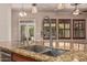 Kitchen island with stainless steel sink, granite countertop, and views to the outside at 4318 N 180Th Dr, Goodyear, AZ 85395
