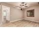 Bright living room featuring wood floors, ceiling fan, and window with shutters at 4318 N 180Th Dr, Goodyear, AZ 85395