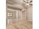 Open-concept living space with wood-look floors, and a view of the dining room with tile flooring at 4318 N 180Th Dr, Goodyear, AZ 85395