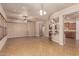 Open concept living room with tile flooring, kitchen island, and ceiling fan at 4318 N 180Th Dr, Goodyear, AZ 85395