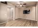 Bright living room featuring wood floors, ceiling fan, and TV at 4318 N 180Th Dr, Goodyear, AZ 85395