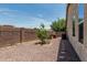 Side yard features desert landscaping with small tree at 4318 N 180Th Dr, Goodyear, AZ 85395