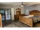 A well-lit bedroom features a sliding door to the backyard, neutral paint, and wood look floors at 4329 W Bloomfield Rd, Glendale, AZ 85304