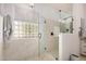 Modern bathroom featuring a glass-enclosed shower, marble tile, and plenty of natural light at 4453 S Huachuca Way, Chandler, AZ 85249
