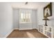 A bedroom featuring neutral carpet, a window with shutters, decor, and a storage unit at 4453 S Huachuca Way, Chandler, AZ 85249