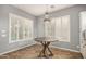 Bright breakfast nook with large windows, plantation shutters, chandelier, and neutral décor at 4453 S Huachuca Way, Chandler, AZ 85249