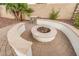 Inviting outdoor fire pit with stone accents and seating area, creating a cozy space for gatherings at 4453 S Huachuca Way, Chandler, AZ 85249