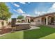 Backyard with a hot tub and artificial turf, creating a private retreat for relaxation and enjoyment at 4453 S Huachuca Way, Chandler, AZ 85249