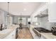 Spacious kitchen with island, stainless steel appliances, granite countertops, and chandelier lighting at 4453 S Huachuca Way, Chandler, AZ 85249