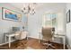 Bright home office featuring hardwood floors, two desks, chandelier, and natural light from large windows at 4453 S Huachuca Way, Chandler, AZ 85249