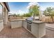 Outdoor kitchen featuring a built-in grill and counter space, perfect for entertaining in the backyard at 4453 S Huachuca Way, Chandler, AZ 85249