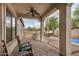Covered patio with ceiling fan, tile flooring, an outdoor kitchen, and a backyard view at 4453 S Huachuca Way, Chandler, AZ 85249