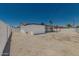 Exterior of home features a gravel yard, covered patio, and white fencing at 4613 N 53Rd Dr, Phoenix, AZ 85031