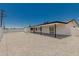 Expansive backyard featuring a white exterior, gravel, and covered patio, creating a welcoming outdoor space at 4613 N 53Rd Dr, Phoenix, AZ 85031