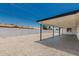 Covered patio sits in backyard that features gravel and perimeter wall for privacy at 4613 N 53Rd Dr, Phoenix, AZ 85031