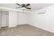 Well-lit bedroom with large closet, carpet and ceiling fan at 4613 N 53Rd Dr, Phoenix, AZ 85031