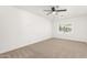 Simple bedroom featuring neutral carpet, ceiling fan and window with a view at 4613 N 53Rd Dr, Phoenix, AZ 85031