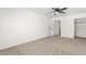 Simple, bright bedroom with carpet, ceiling fan, doorway and closet at 4613 N 53Rd Dr, Phoenix, AZ 85031