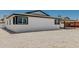 Exterior view of home features rock landscaping, fresh paint and trim, and a convenient covered carport at 4613 N 53Rd Dr, Phoenix, AZ 85031