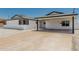 Exterior view of a bright white home with a covered carport and fresh rock landscaping in a desirable neighborhood at 4613 N 53Rd Dr, Phoenix, AZ 85031