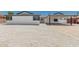 Exterior view of a bright white home features rock landscaping, fresh paint and trim, and a covered carport at 4613 N 53Rd Dr, Phoenix, AZ 85031