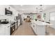 Well-equipped kitchen featuring stainless steel appliances, white cabinetry, and a large center island at 4613 N 53Rd Dr, Phoenix, AZ 85031