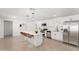 Bright kitchen with white cabinets, stainless steel appliances, and an island with bar seating at 4613 N 53Rd Dr, Phoenix, AZ 85031