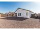 A zero-scape backyard features a beige brick perimeter wall and white house at 513 S 115Th Dr, Avondale, AZ 85323