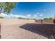 An enclosed backyard with low maintenance gravel and a beige perimeter wall at 513 S 115Th Dr, Avondale, AZ 85323